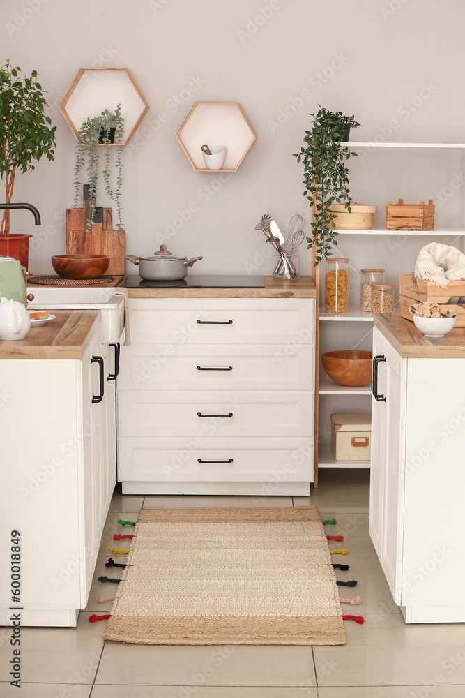 Stylish rug on floor in kitchen