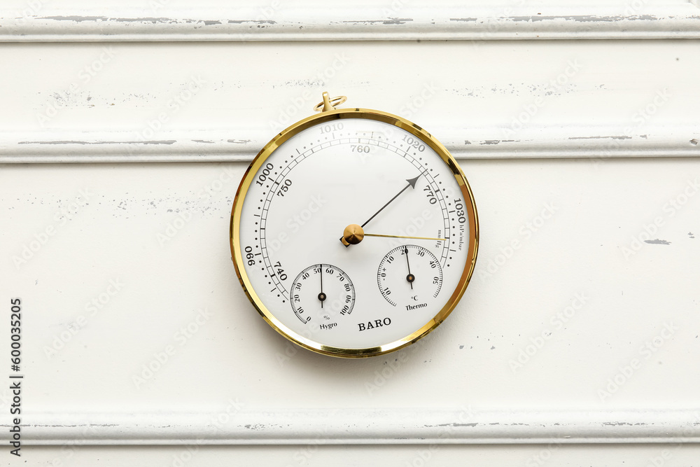 Aneroid barometer on white wooden background