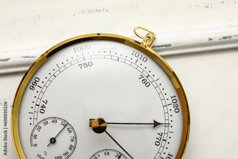 Aneroid barometer on white wooden background