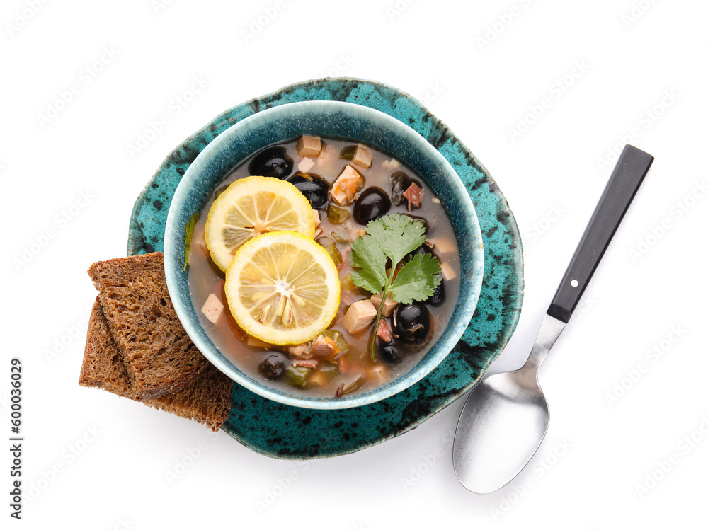 Bowl of tasty Hodgepodge soup with bread on white background