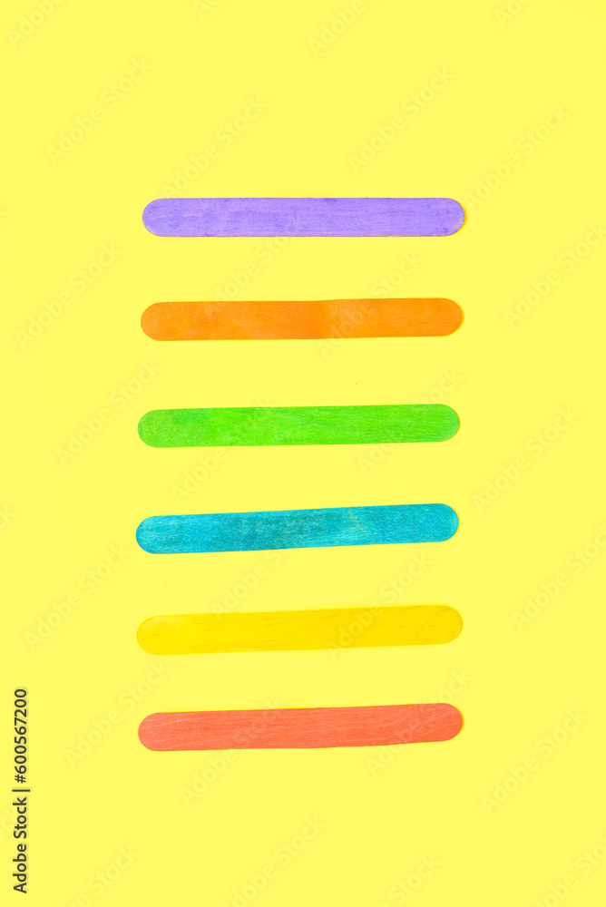 Colorful ice cream sticks on beige background