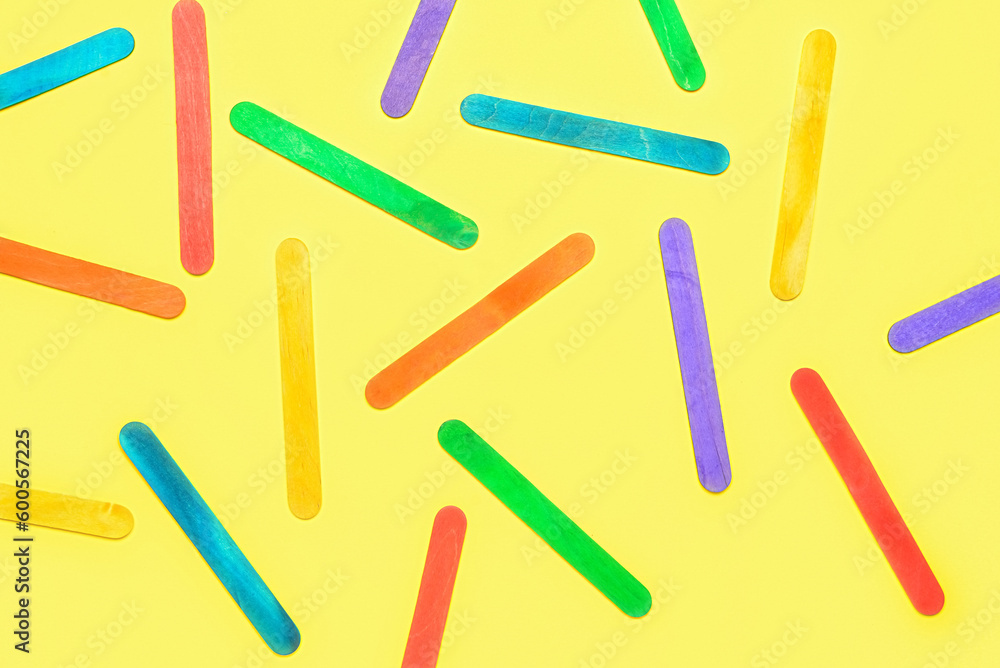 Colorful ice cream sticks on beige background