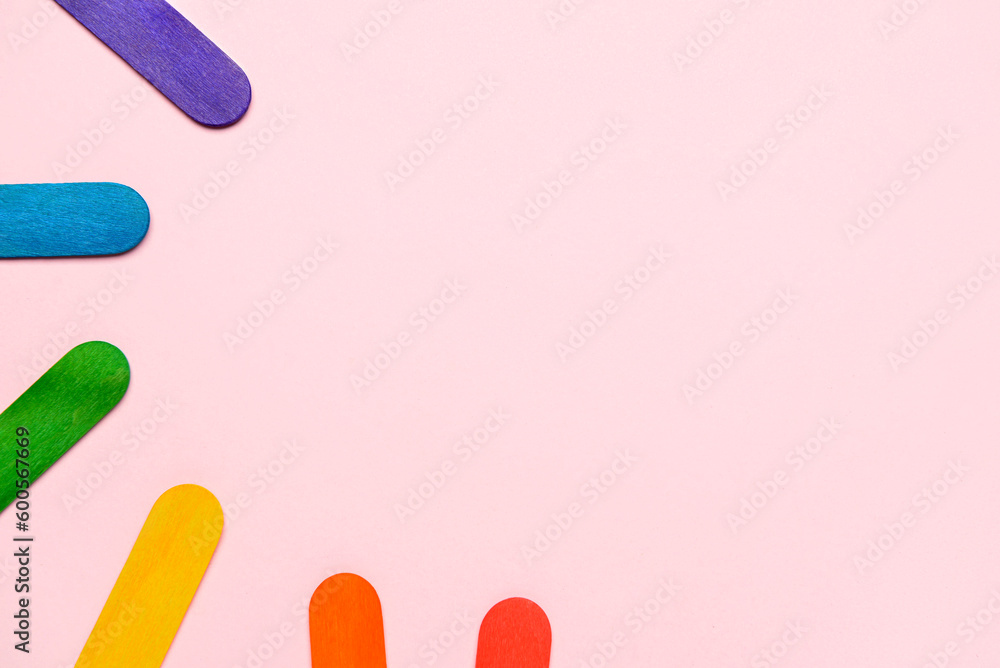 Colorful ice cream sticks on pink background