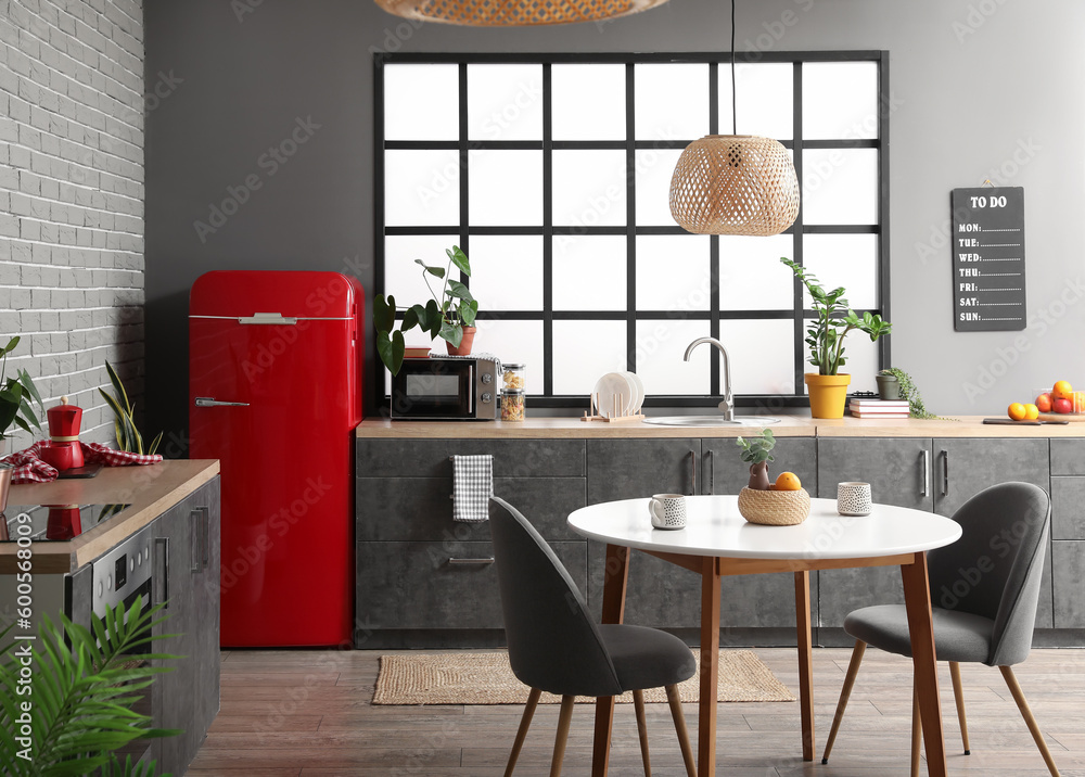 Interior of modern kitchen with stylish refrigerator