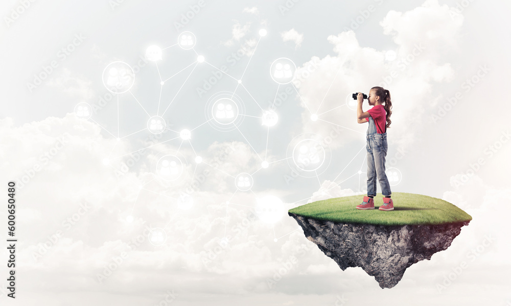 Concept of careless happy childhood with girl looking in binoculars