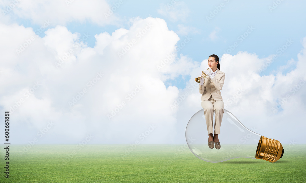 Business woman sitting on big light bulb