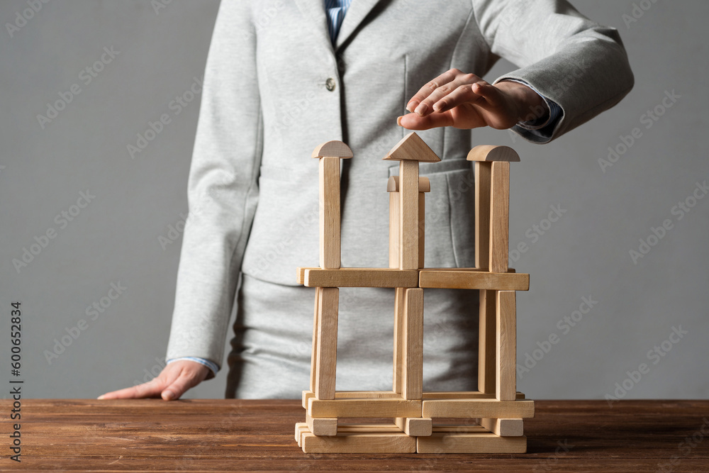 Business woman building tower on table