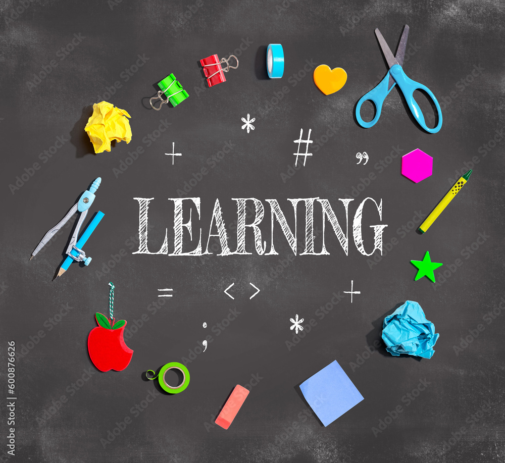 Learning concept with school supplies on a chalkboard - flat lay