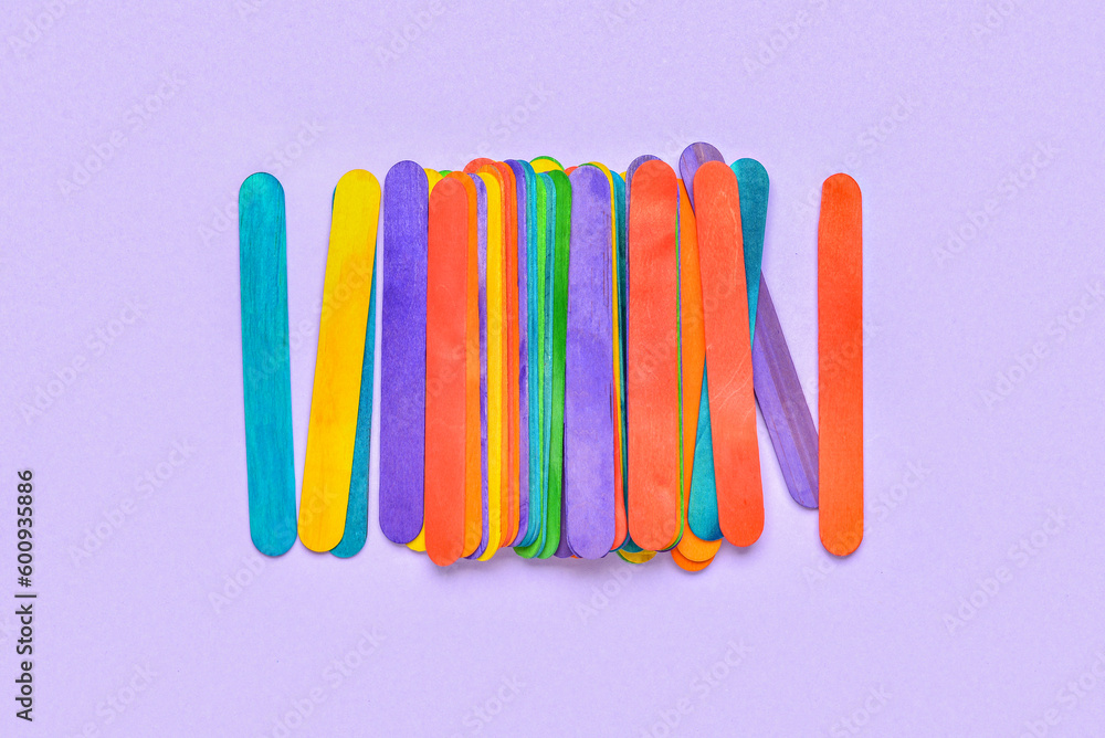 Colorful ice cream sticks on purple background