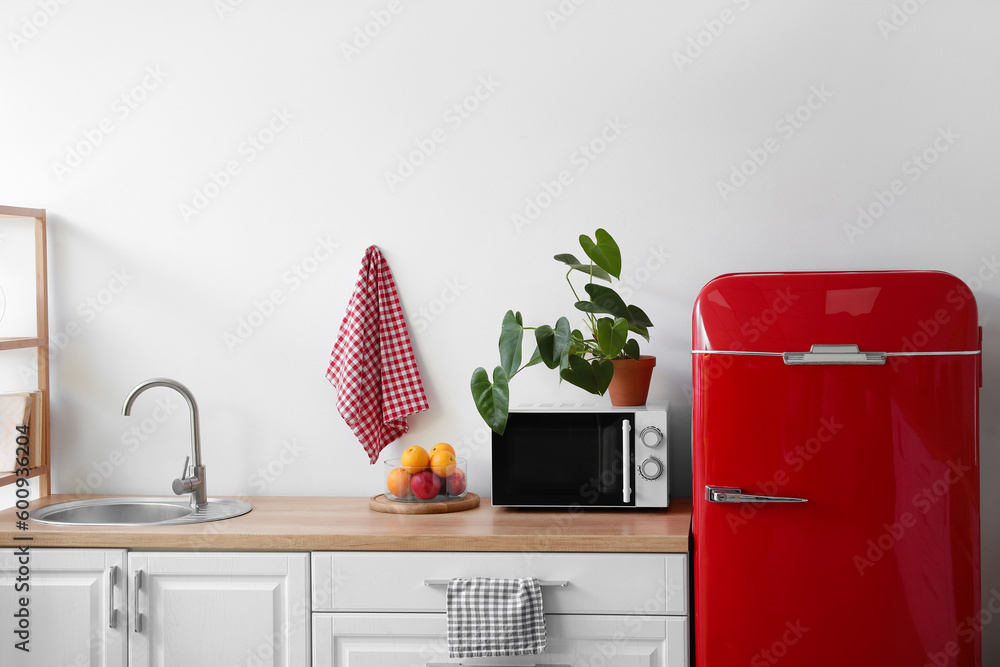 Interior of modern kitchen with stylish refrigerator