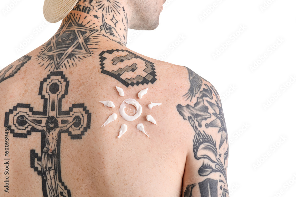 Tattooed man with sunscreen cream on his skin against white background, closeup