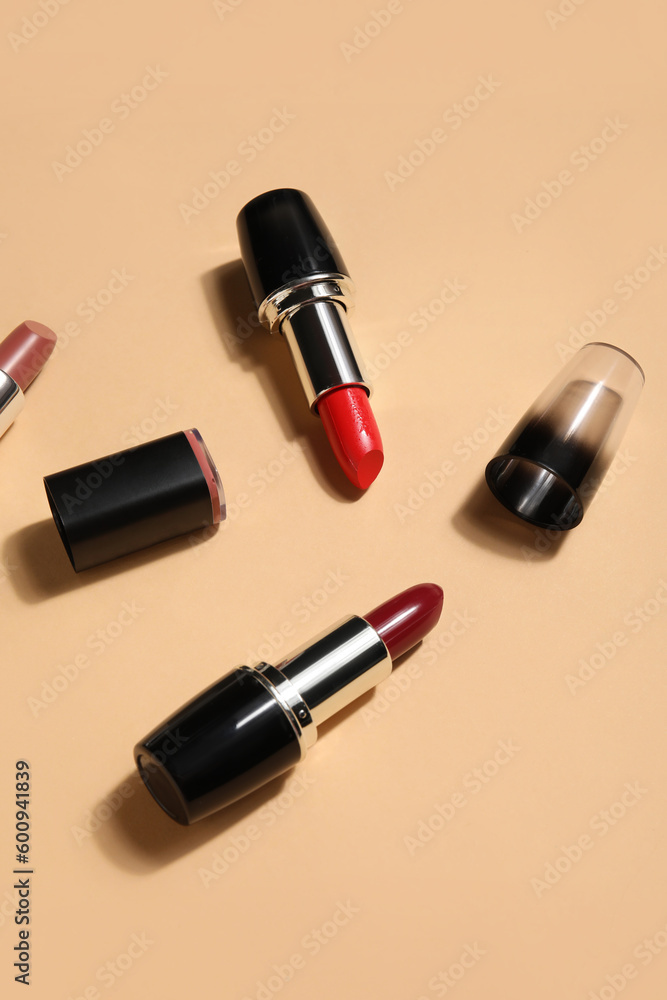 Different lipsticks on beige background