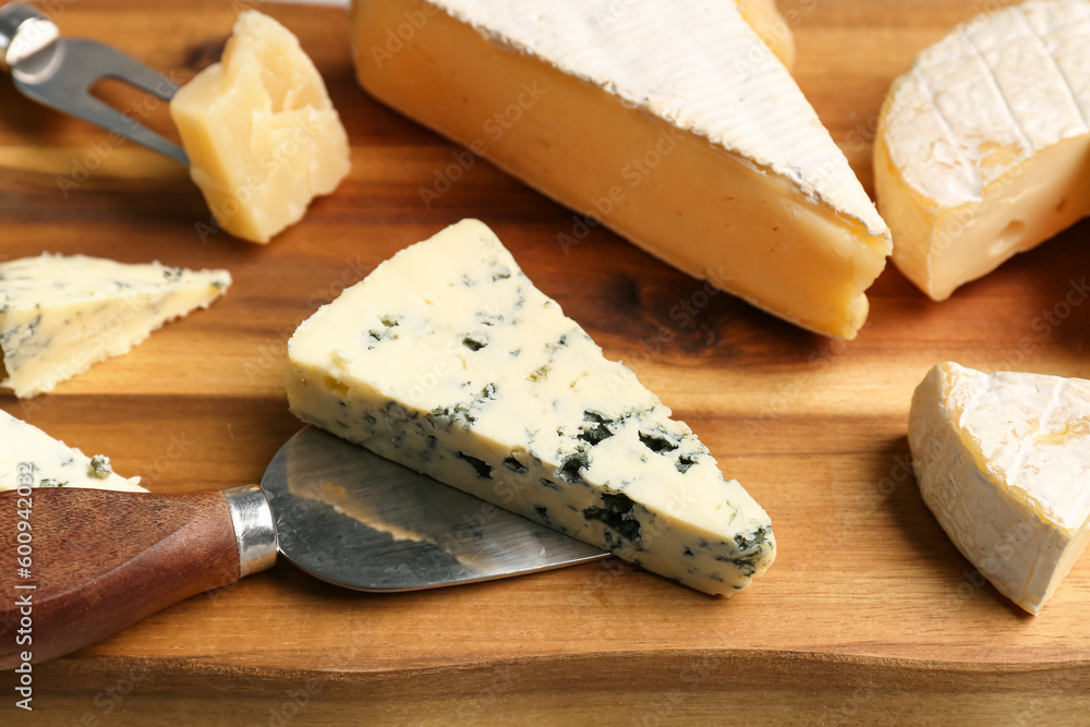 Different types of tasty cheese on table, closeup