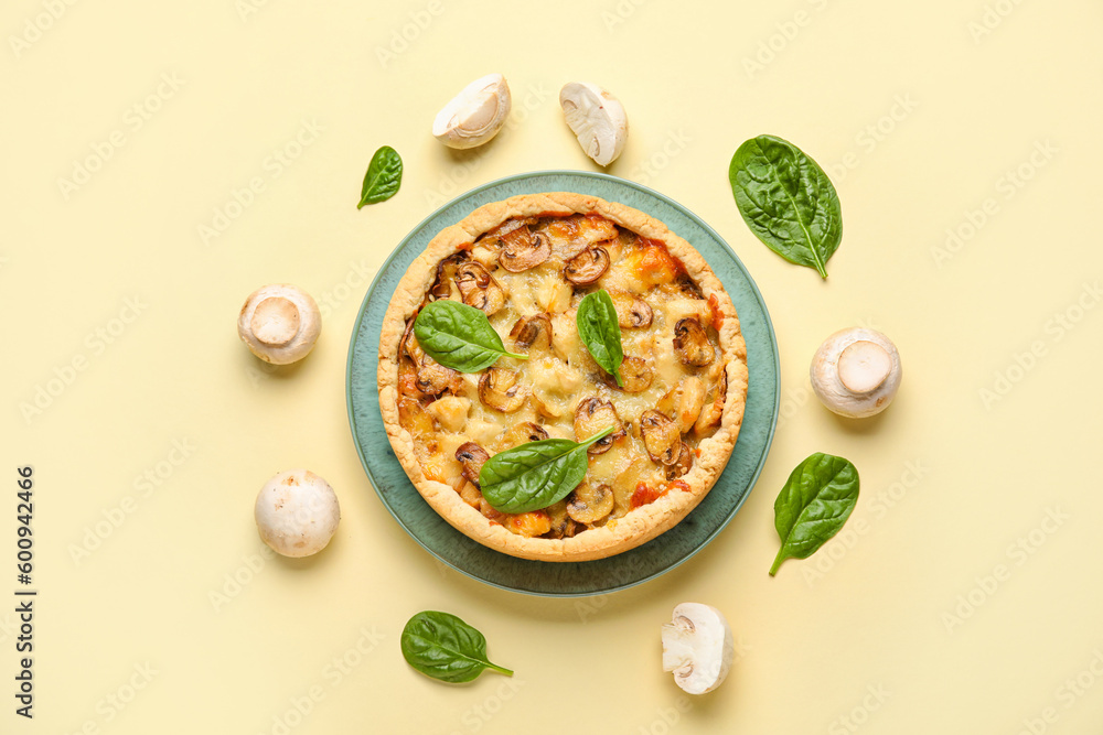 Mushroom pie with spinach leaves and champignons on yellow background