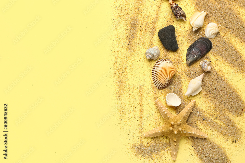 Sand with starfish and shells on light yellow background