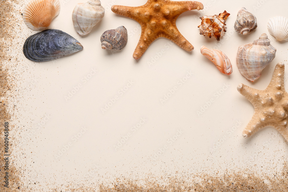 Frame made of sand, starfishes and seashells on white background