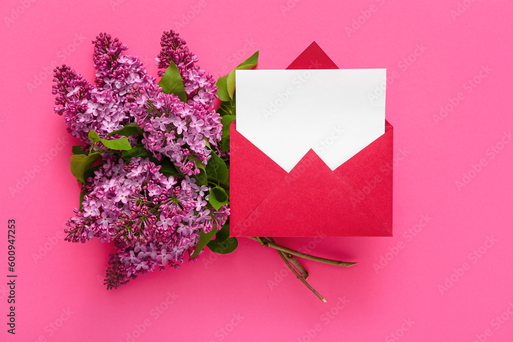 Red envelope with blank card and bouquet of lilacs on pink background