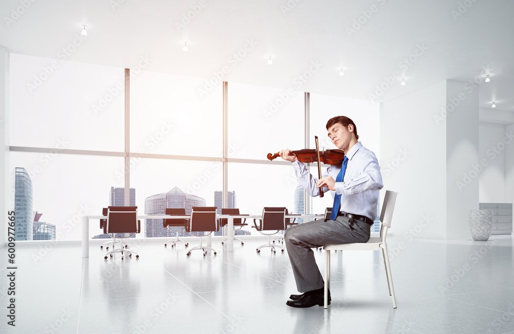 young businessman playing violin