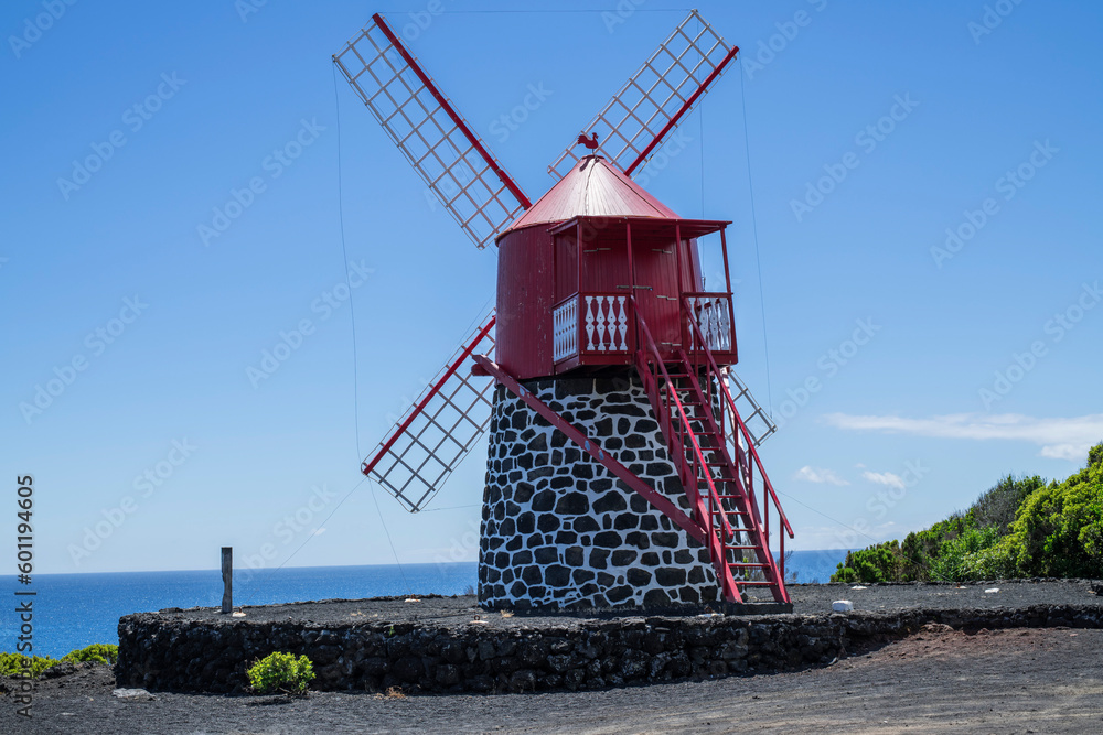 Red windmill / A red windmill on the coast of Pico island, Azores.