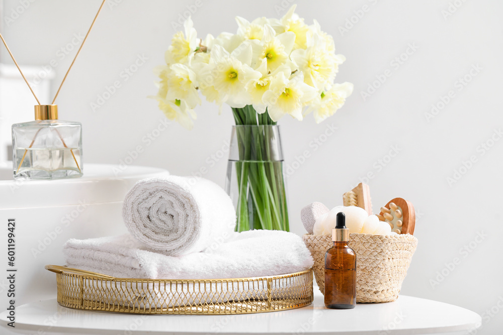 Bathing supplies and bouquet of flowers on table