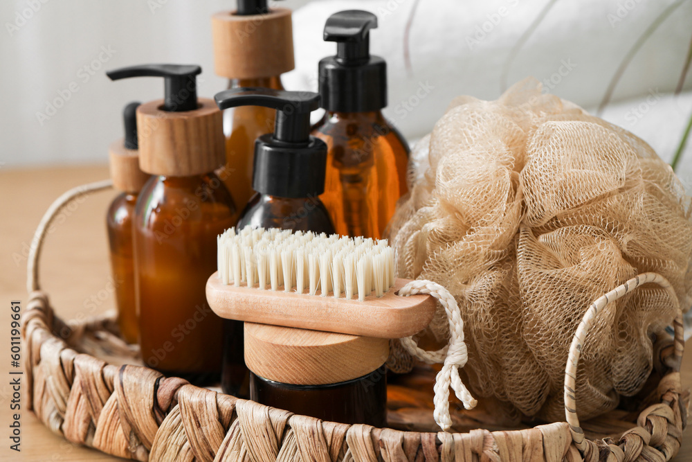 Wicker tray with bathing supplies on table, closeup