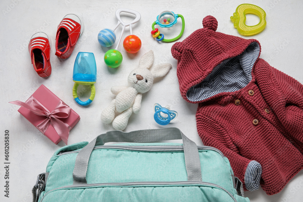 Composition with baby clothes, toys and accessories on white background