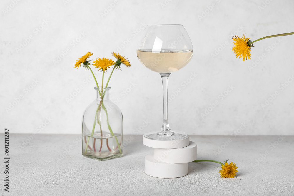 Glass of dandelion wine on white table