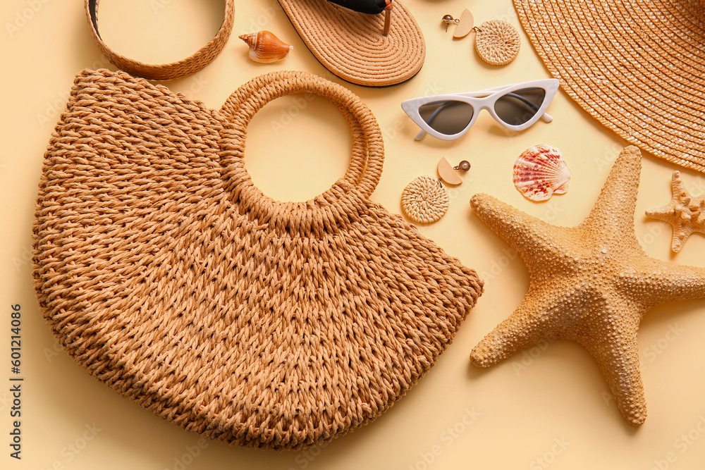 Stylish bag and different accessories on beige background