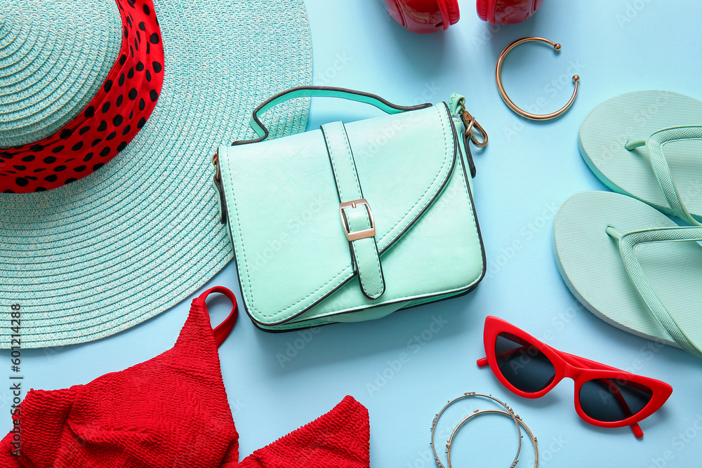 Stylish bag and different accessories on blue background