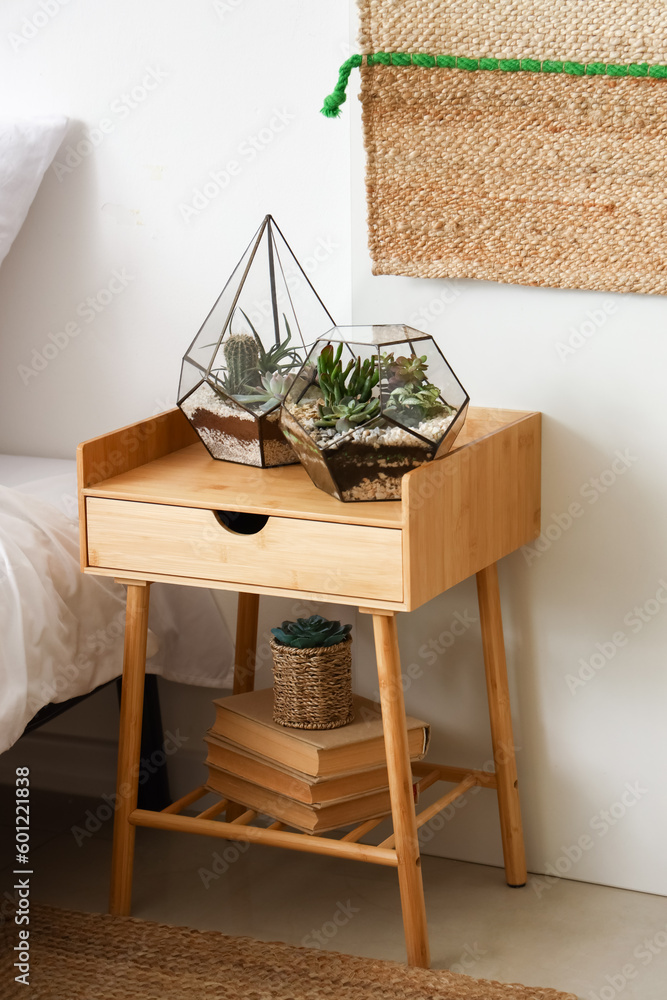 Florariums on table in light bedroom