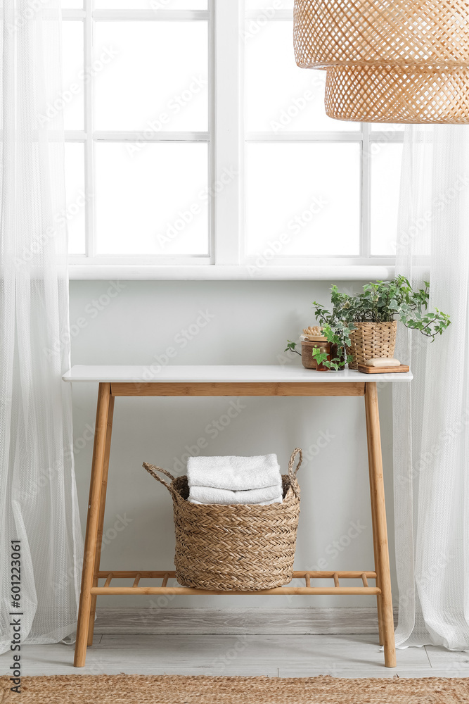 Interior of bathroom with table near window