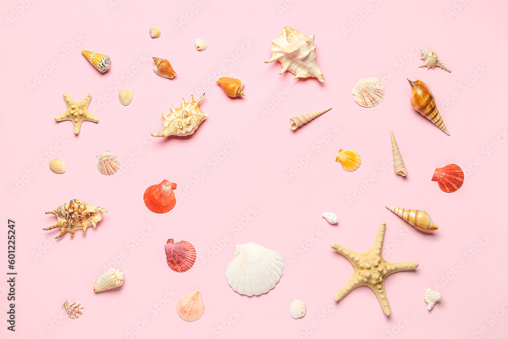 Frame made of seashells and starfishes on pink background