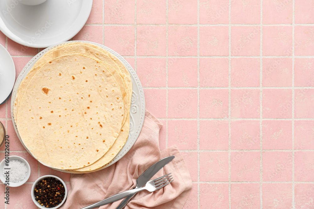 Plate with fresh lavash on pink tile background