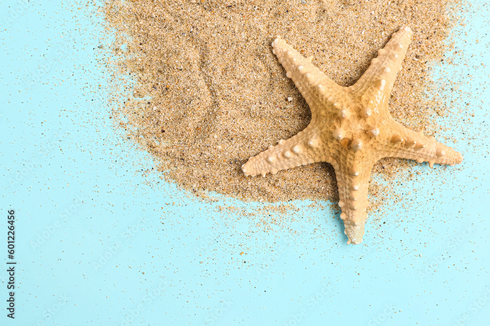 Sand with starfish on blue background