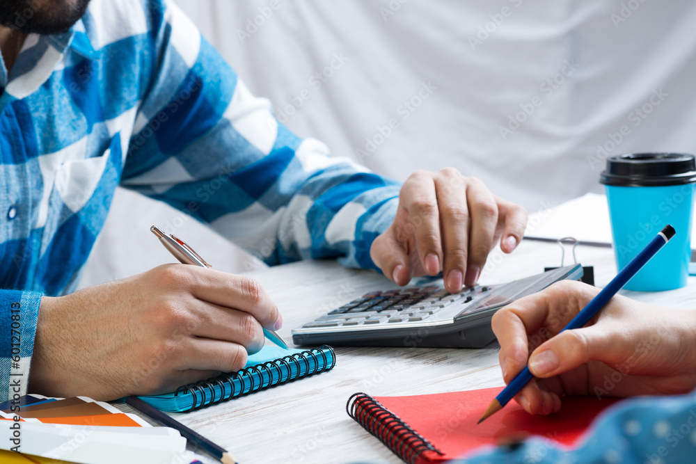 Developers calculating project at desk