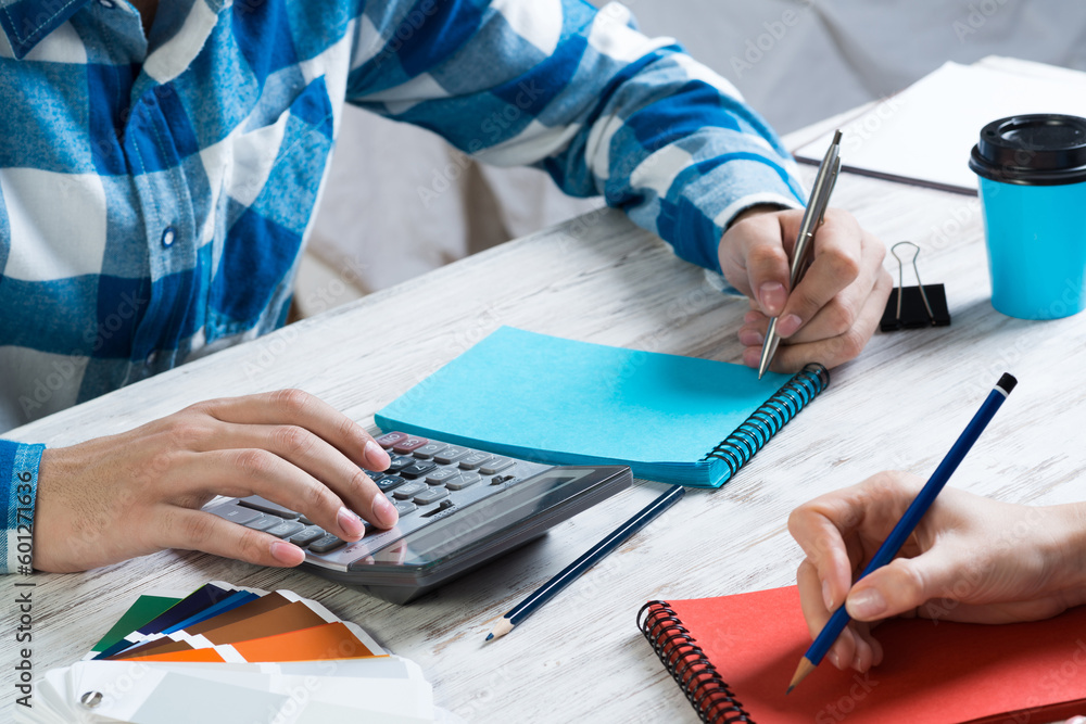 Developers calculating project at desk