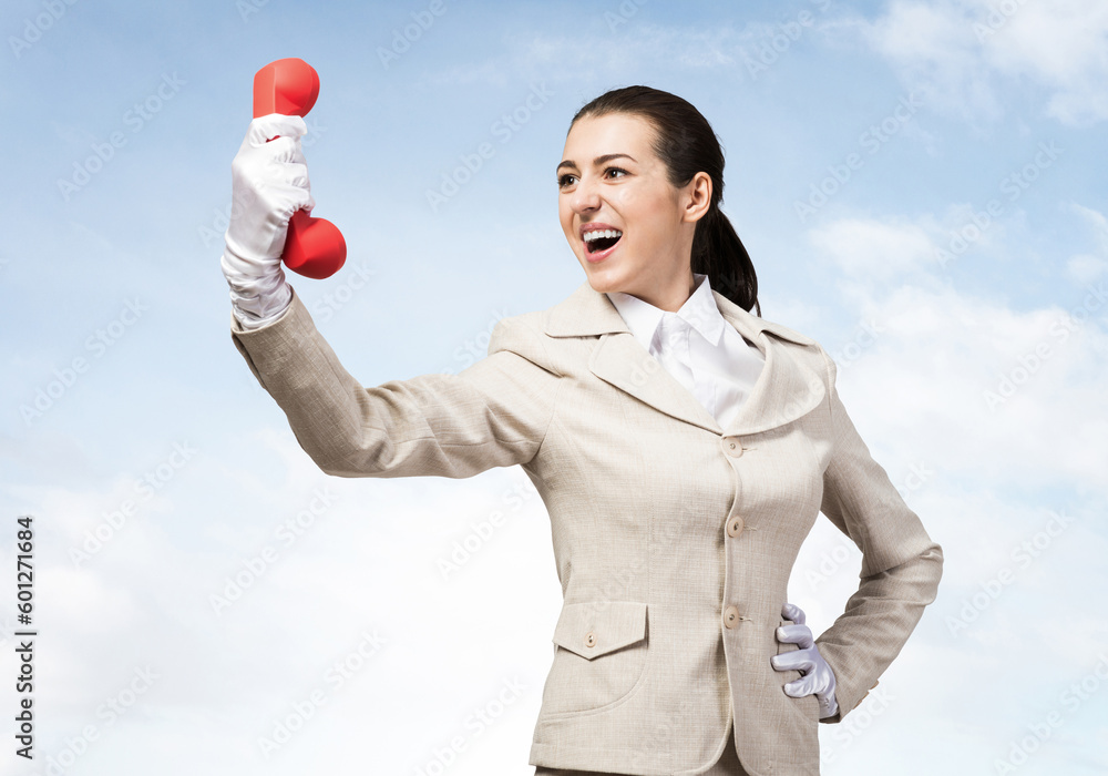 Expressive woman holds handset phone on distance