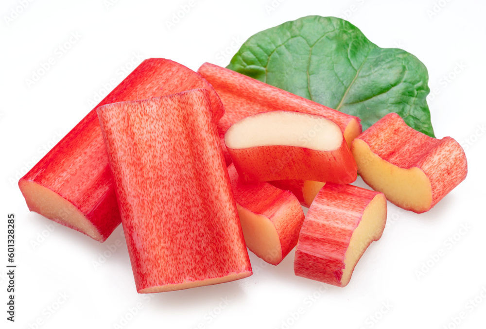 Red rhubarb stems cuts over rhubarb leaves isolated on white background.