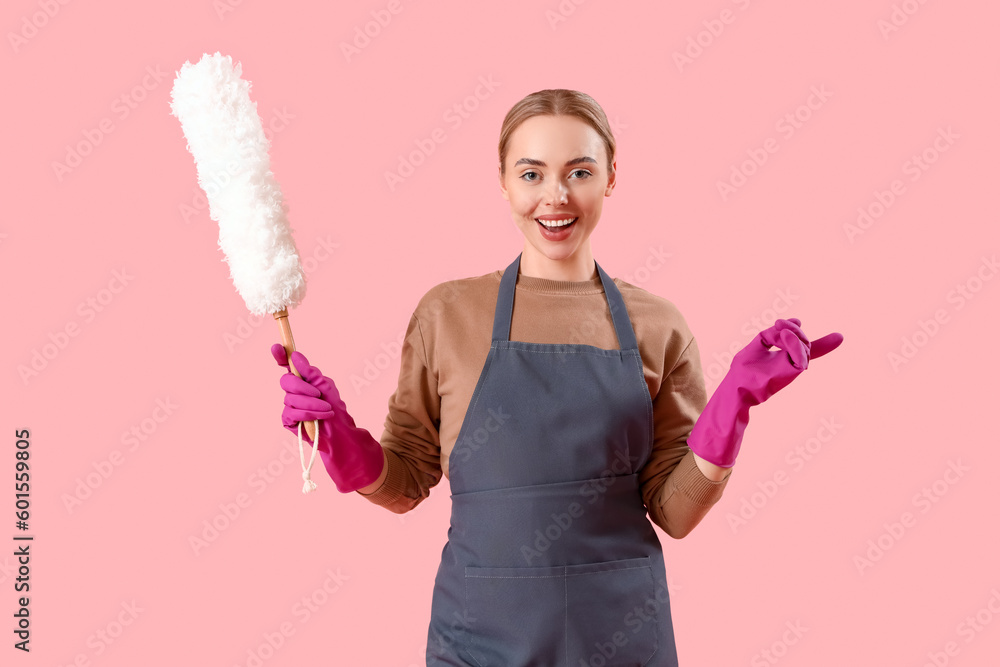 Young woman with pp-duster on pink background