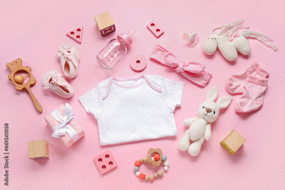 Composition with baby clothes, toys and accessories on light pink background