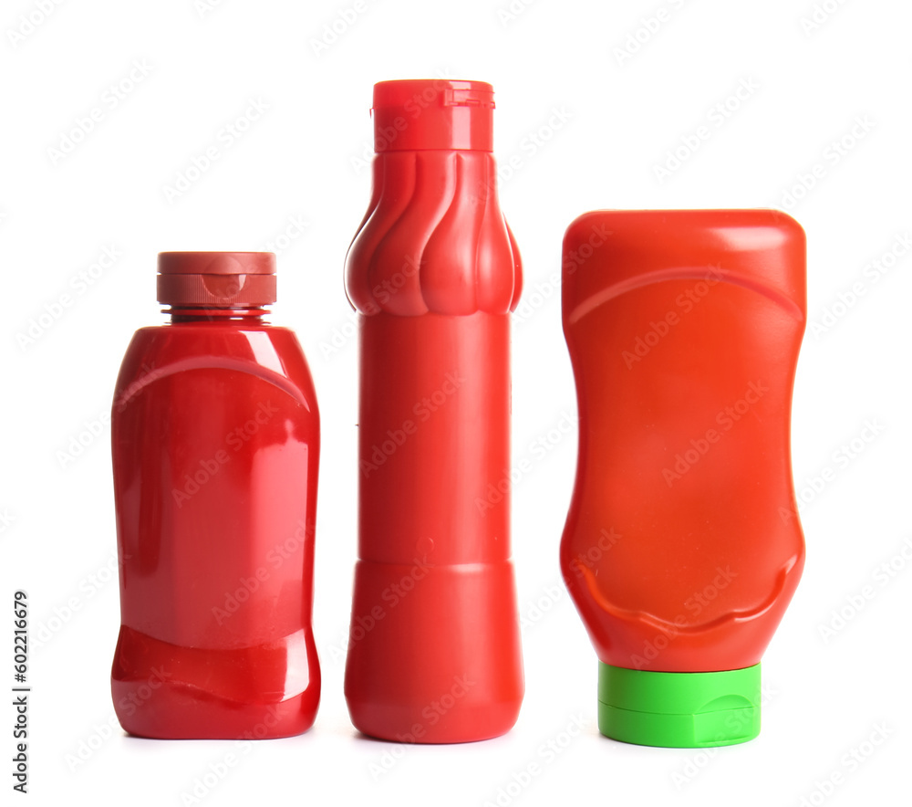 Plastic bottles of ketchup on white background