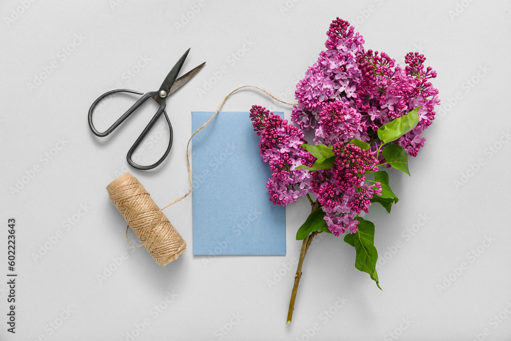 Blank card and bouquet of lilacs on grey background