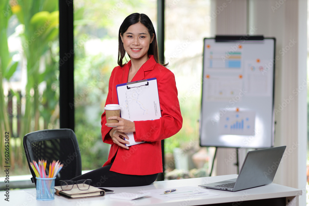 Attractive asian business woman secretary portrait at office desk.