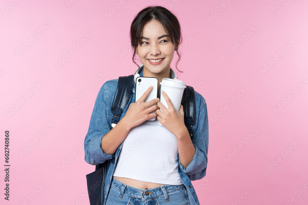 Portrait of young Asian woman student standing with smartphone coffee and backpack.College Teenager 