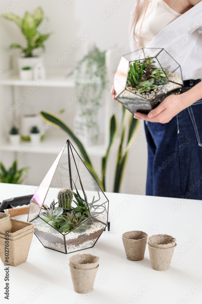 Woman with florariums at home, closeup