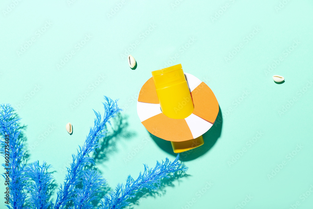 Creative composition with sunscreen cream and lifeline on turquoise background