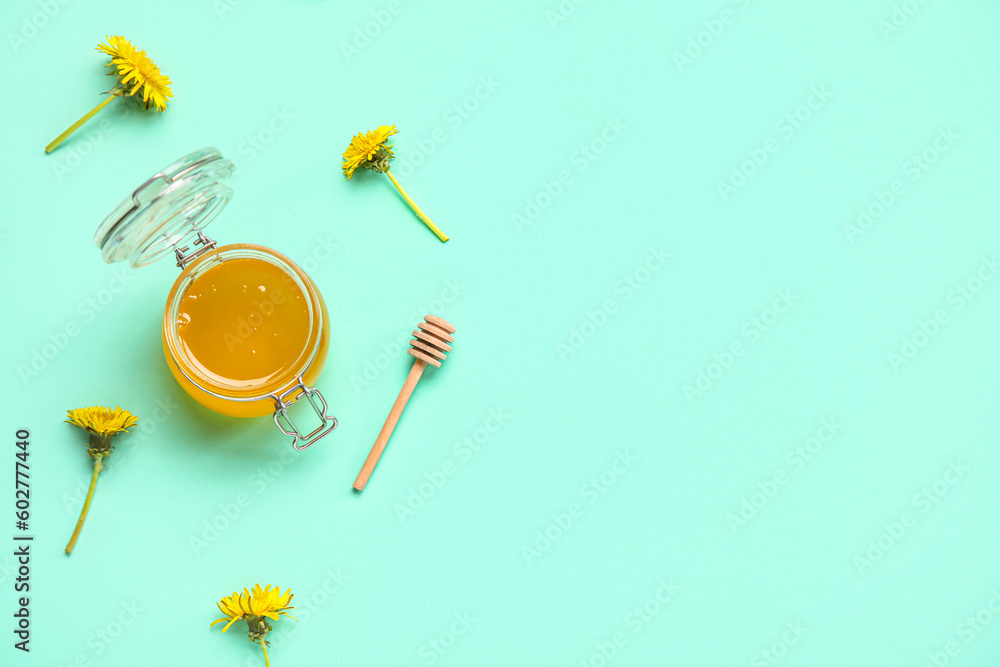 Jar with dandelion honey on turquoise background