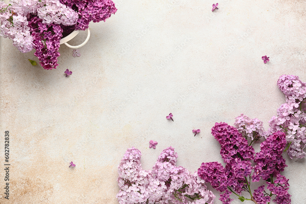 Colander with beautiful fragrant lilac flowers on white textured background