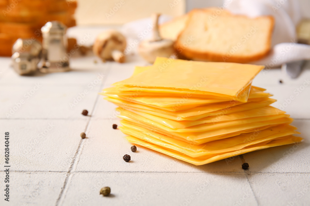 Slices of tasty processed cheese on table