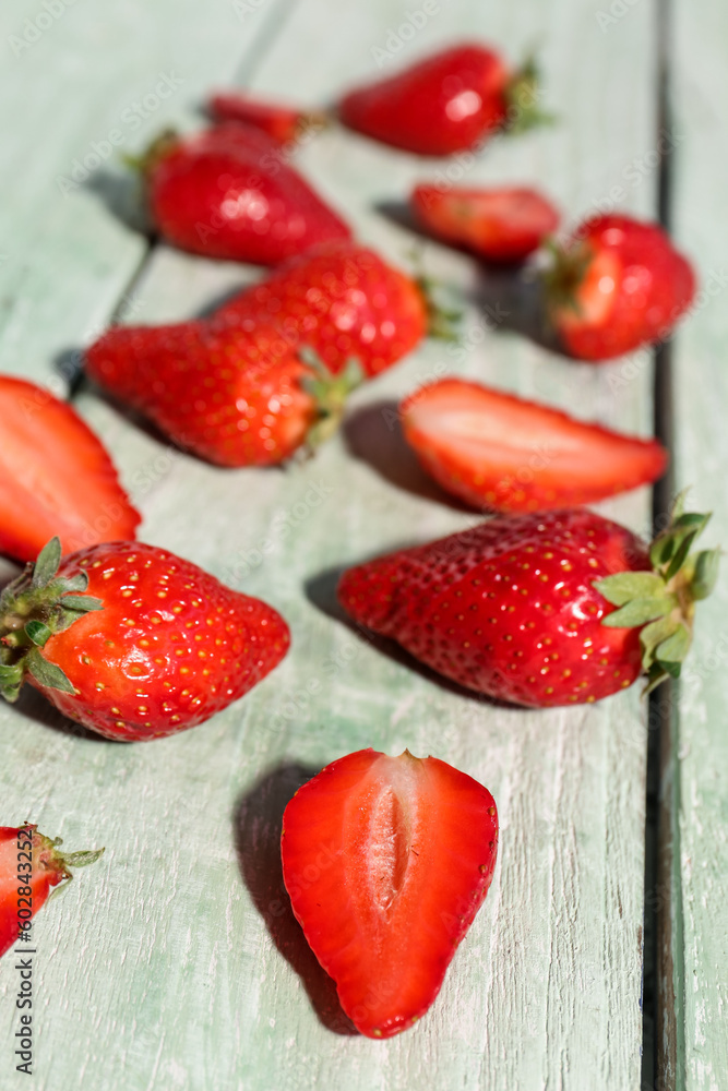 Fresh strawberries on green wooden background